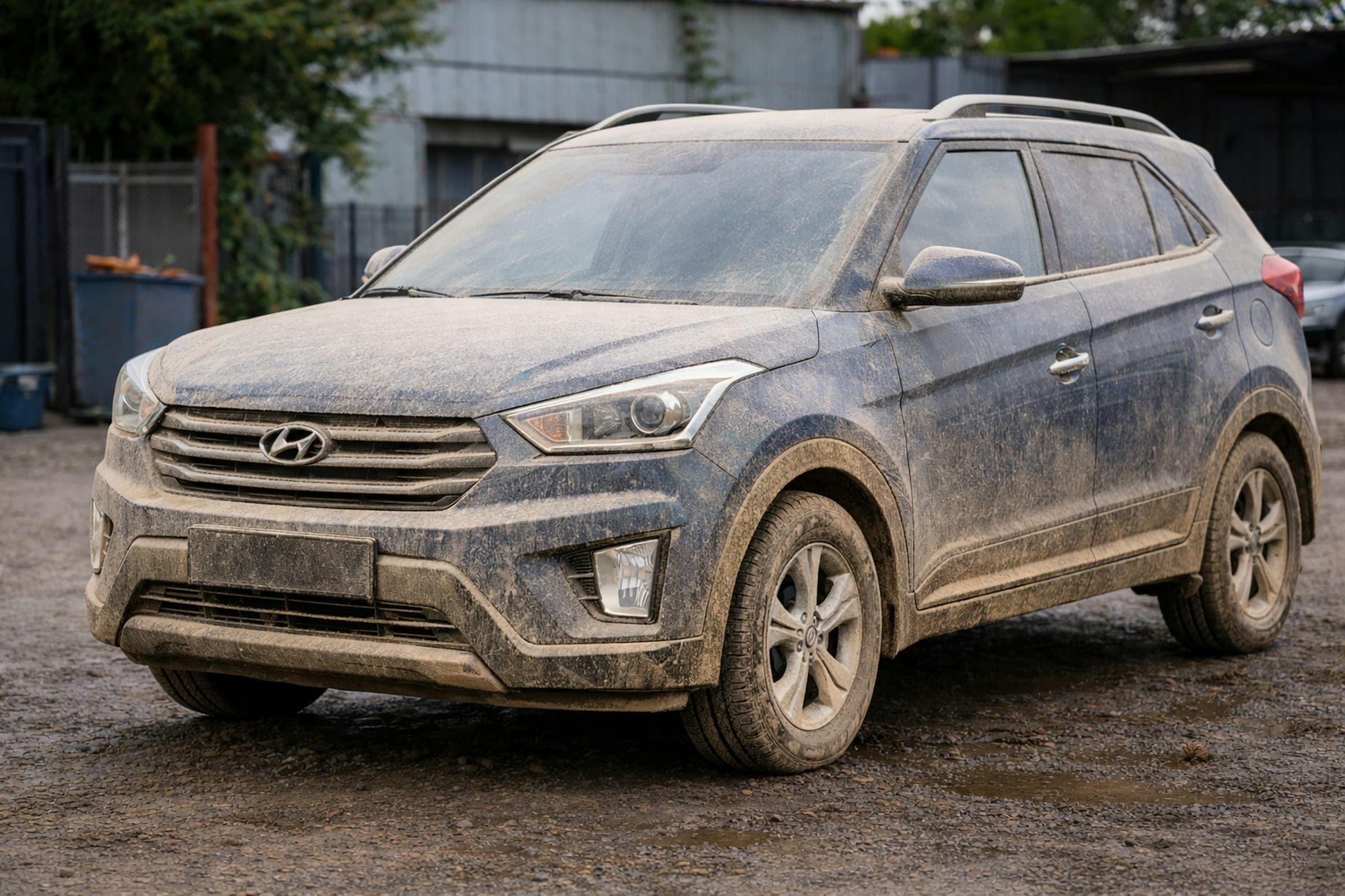 A dark blue SUV caked in dried mud